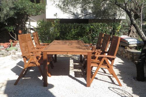a wooden table and two chairs sitting around a wooden table at Apartments with a parking space Cres - 7876 in Cres