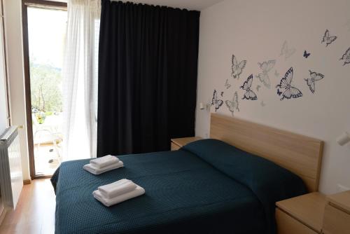 a bedroom with a bed with two towels on it at Apartments with parking space Cres - 7876 in Cres
