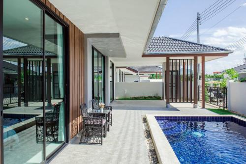 an external view of a house with a swimming pool at 2 Bed Contemporary Pool Villa in Hua Hin