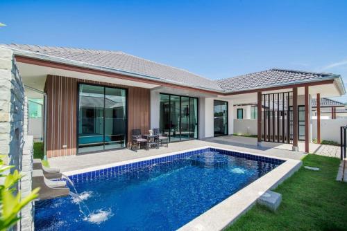 a swimming pool in the backyard of a house at 2 Bed Contemporary Pool Villa in Hua Hin