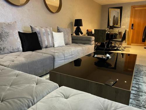 a living room with a couch and a table at Luxury apartment in downtown of kenitra in Kenitra