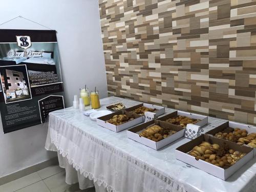 a table with several boxes of food on it at Hotel Sur Brasil in Ciudad del Este