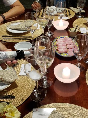 a table with glasses of wine and food on it at Pousada Tekoá Indiana in Cachoeiras de Macacu