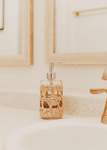a soap dispenser sitting on a bathroom sink at Puamana Maluhia - Two Bedroom / Two Bath Condo in Princeville