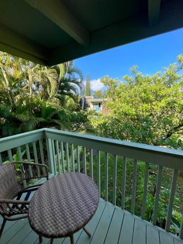 a balcony with a table and a chair on a deck at Puamana Maluhia - Two Bedroom / Two Bath Condo in Princeville