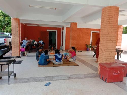 a group of children sitting on the floor of a room at Ma Baan House by the sea in Cha Am Beach
