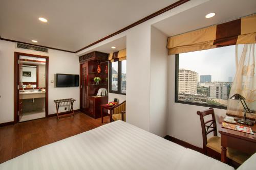 a hotel room with a bed and a window at May De Ville Trendy Hotel & Spa in Hanoi