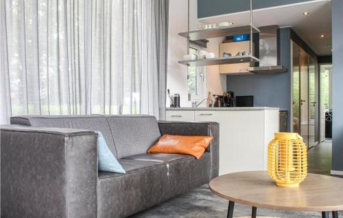 a living room with a couch and a table at Awesome Ship In Warns With Kitchen in Warns