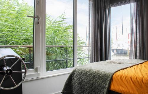 a bedroom with a bed and a large window at Awesome Ship In Warns With Kitchen in Warns