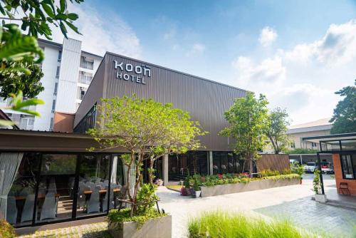 a building with a kochi hotel sign on it at Koon Hotel Sukhumvit in Bangna