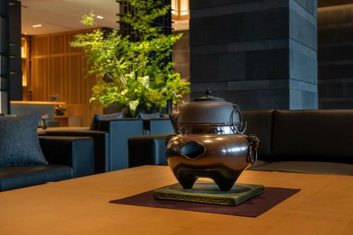 a statue sitting on a table in a lobby at Pearl Star Hotel ATAMI in Atami