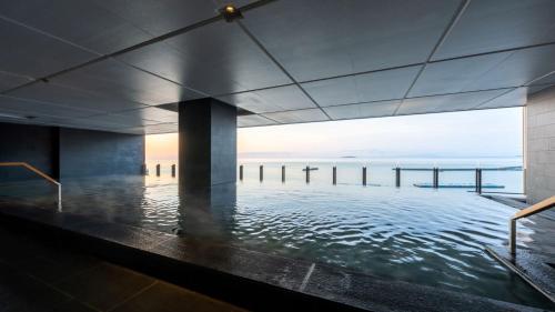 a swimming pool with a view of the ocean at Pearl Star Hotel ATAMI in Atami