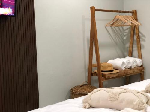 a bedroom with a bed and a basket of towels at My home resort - ขนอม นครศรีธรรมราช in Khanom