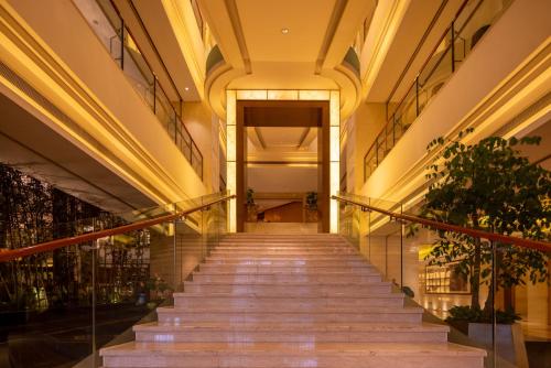 a long staircase in a building with lights at Shenzhen Baolilai International Hotel (Baoan, Fuyong) in Bao'an