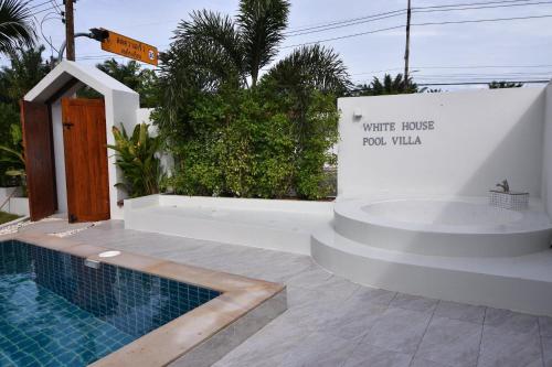 a sign that reads write haste fool villa next to a swimming pool at My home resort - ขนอม นครศรีธรรมราช in Khanom