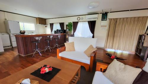 a living room with a couch and a table at Océanos - Sunset, BBQ, Beach & Kayak - オケアノス in Ishigaki Island