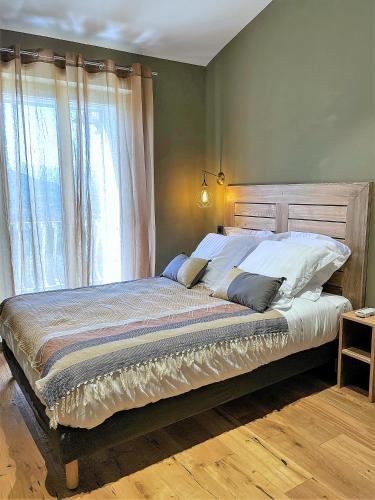 a bedroom with a large bed with a large window at A Villa di Rutali in Rutali