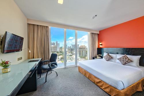 a hotel room with a bed and a large window at Pearl Grand By Rathna in Colombo
