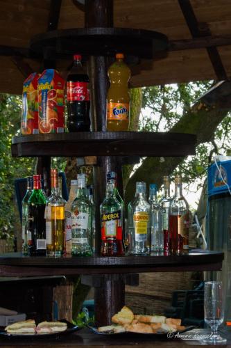 a shelf filled with lots of bottles of alcohol at Hotel Monti in Lamporecchio