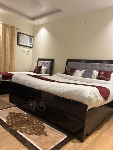 a bedroom with a large bed in a room at The Divine Oak Golden Leaf in Katra