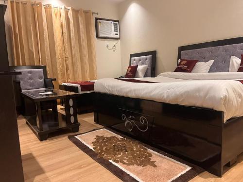 a bedroom with a large bed and a table at The Divine Oak Golden Leaf in Katra