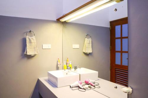 a bathroom with a white sink and a mirror at Nature Walk Ella in Ella