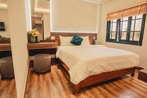 a bedroom with a large bed and a window at Villa Hoa Da in Da Lat
