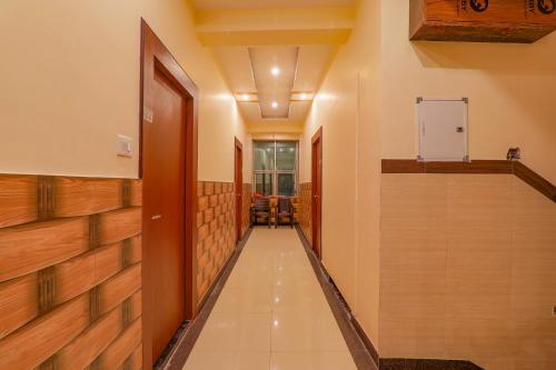 a corridor in a building with wooden walls and a hallway at FabHotel Shree Galaxy in Kānpur