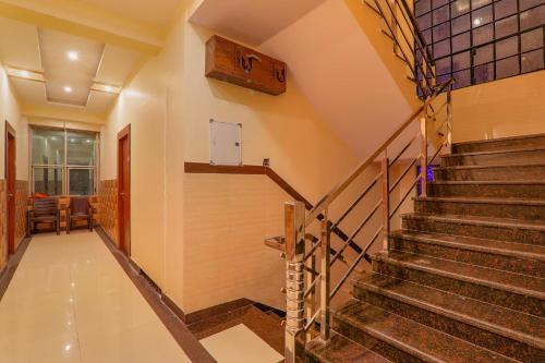 a staircase in a home with a stair case at FabHotel Shree Galaxy in Kānpur