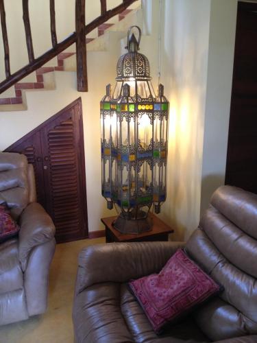 a living room with a couch and a chandelier at Marula Park in Diani Beach