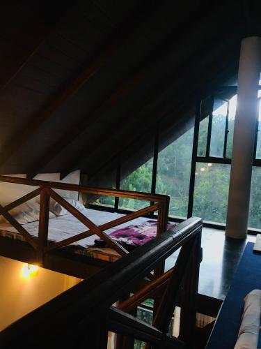 a bedroom with two bunk beds and a large window at Mirador Cottage in Bandarawela