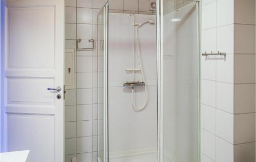 a shower with a glass door in a bathroom at Beautiful Apartment In Vgslid With 2 Bedrooms And Wifi in Vågsli