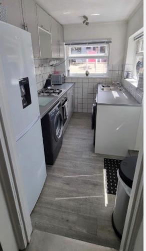 uma pequena cozinha com um frigorífico e um fogão em New, spacious & immaculate Double room for rental in Colchester Town Centre! em Colchester