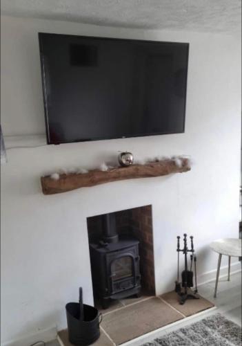 uma lareira com uma televisão de ecrã plano por cima em New, spacious & immaculate Double room for rental in Colchester Town Centre! em Colchester