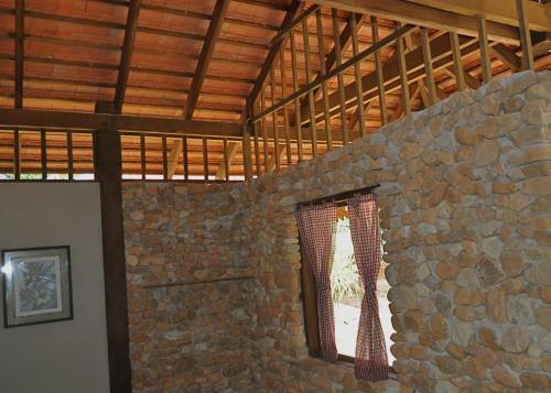 a stone wall in a room with a window at Khmer Hands in Kep
