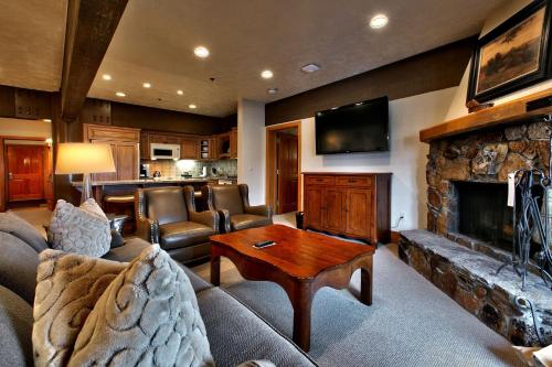 a living room with a couch and a fireplace at Luxury Three Bedroom Suite with Mountain Views and Hot Tub apartment hotel in Park City