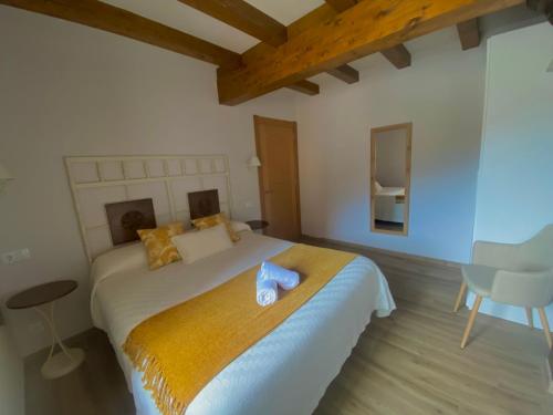 a bedroom with a bed with a blue towel on it at Apartamentos La Ventana de Mogrovejo in Mogrovejo