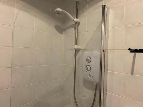 a shower with a shower head in a bathroom at 105 Nelson str Ground Right in Largs
