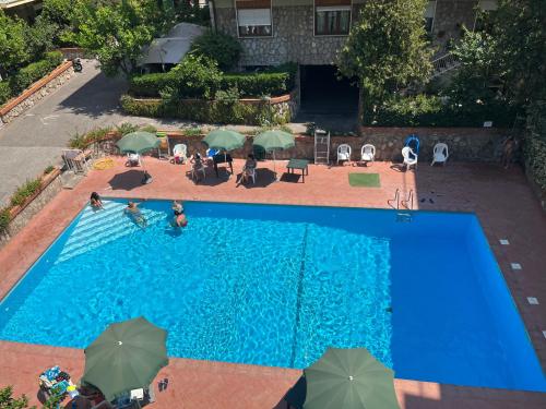 an overhead view of a swimming pool with umbrellas at Sorrento's Carme family big appartament in Sorrento