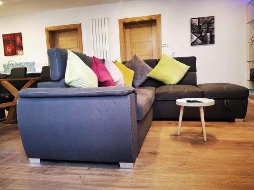 a couch with colorful pillows on it in a living room at Ard Kielin Apartment Luxury 2 bedroom in Killarney in Killarney