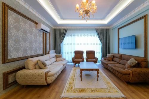 a living room with a couch and a table at Pearl of Cappadocia in Avanos