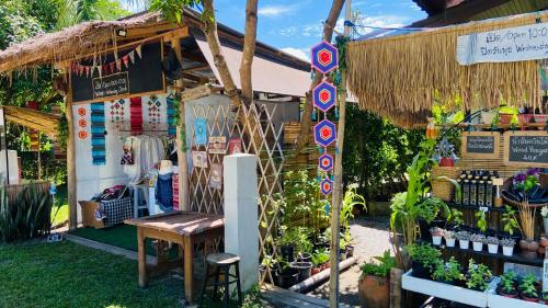 a garden shop with a bench in front of it at Sean Sabai Home e Ristobar in Taling Ngam Beach