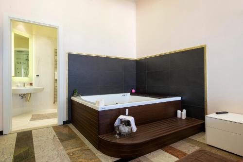 a bathroom with a tub and a sink at Hotel Residence Imperial in Misano Adriatico