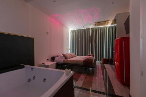 a bedroom with a bed and a tub in a room at Hotel Residence Imperial in Misano Adriatico