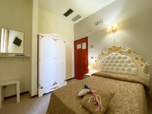 a bedroom with a large bed and a dresser at HOTEL RINASCIMENTO in Montecatini Terme