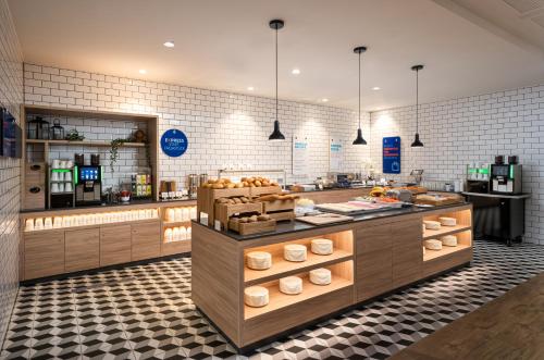 a kitchen with a counter with food on it at Holiday Inn Express - Rosenheim by IHG in Rosenheim