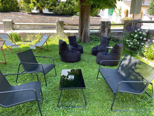 a group of chairs and tables in the grass at Goldener Adler in Scharnitz