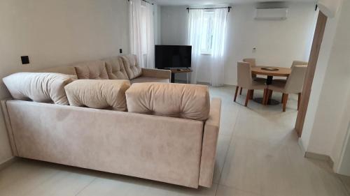 a living room with a couch and a table at Apartments ANA Karlobag in Karlobag