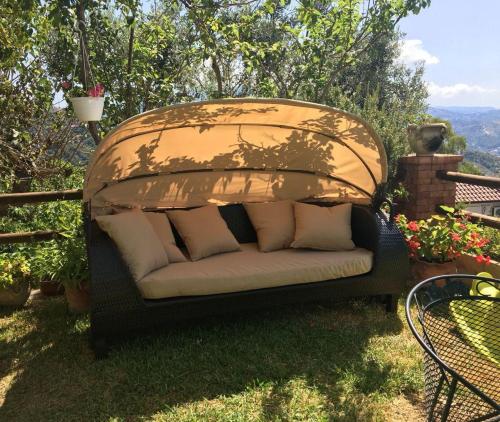 a couch sitting in the grass on a patio at Casa Teresina in Castellabate