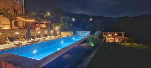 a swimming pool in a backyard at night at A Villa di Rutali in Rutali